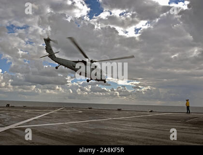 191108-N-comme la mer Tyrrhénienne200-0157 (nov. 8, 2019) Un hélicoptère MH-60 Sea Hawk, attaché à la "Dragon" les baleines de la mer de l'Escadron d'hélicoptères de combat (HSC) 28 Départ de l'Blue Ridge-class et de contrôle, le USS Mount Whitney (LCC 20) en traversant la mer Tyrrhénienne, le 8 novembre 2019. Mount Whitney est la sixième flotte américaine, homeported phare à Gaeta, Italie et fonctionne avec un équipage de marins américains de transport maritime militaire et civil service commande marins. (U.S. Photo par marine Spécialiste de la communication de masse de la classe de 3ème a appelé Verbis/libérés) Banque D'Images