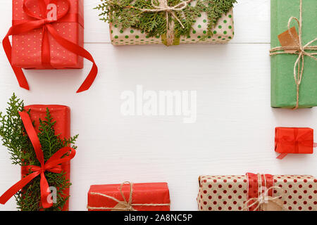 Cadre de Noël composition faite de rouge, vert, brun conçu cadeaux de Noël sur fond de table en bois blanc. Noël, Noël, nouvel an, Banque D'Images