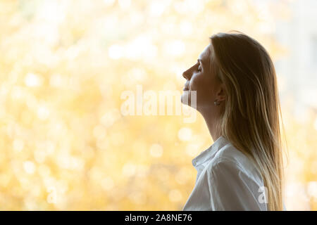 Jeune femme rêveuse méditer respirer l'air frais Banque D'Images