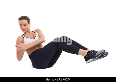 Jeune femme faisant des exercices abs, Fédération de twist, isolated on white Banque D'Images