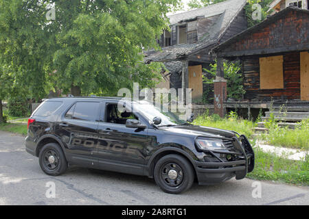 La police de Detroit Gang Enforcement véhicule à l'extérieur des immeubles en ruines, Detroit, Michigan, USA Banque D'Images