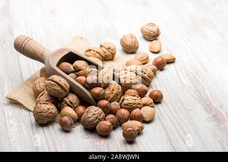 Variété d'écrous avec scoop sur la table en bois Banque D'Images