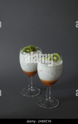 Chia pudding sain dans un verre avec de la confiture de fraises et de kiwis frais Banque D'Images