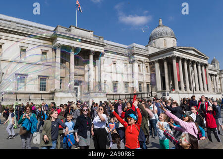 Bubbles créé par un musicien ambulant / street performer , en face de la National Gallery, Trafalgar Square, London, UK Banque D'Images