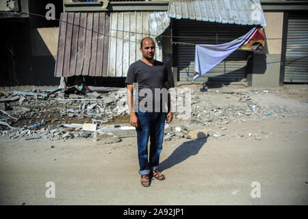 Tel Aviv, Territoires palestiniens. 12 Nov, 2019. Le voisin Ahmad Helles se trouve en face de la maison de l'du Jihad islamique Baha Abu Al Ata, qui a été endommagée à la suite d'un raid aérien israélien. Les forces de sécurité d'Israël ont pris des mesures ciblées afin de tuer le chef militaire du Jihad islamique dans la bande de Gaza. Israël a déclaré qu'il ne serait pas revenir à une politique d'assassinat ciblé. Selon l'armée, il s'agissait d'une action unique pour éviter "une menace directe'. Credit : Saud Abu Ramadan/dpa/Alamy Live News Banque D'Images