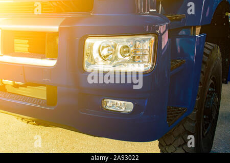 Fragment de l'avant de la cabine du camion en bleu. Flare du soleil. jaune Vue de face. Banque D'Images