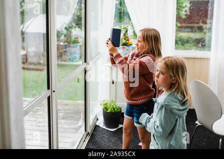 Les filles à la recherche d'une fenêtre Banque D'Images