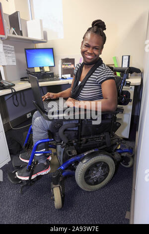 Adolescent avec paralysie cérébrale travaillant dans un bureau Banque D'Images
