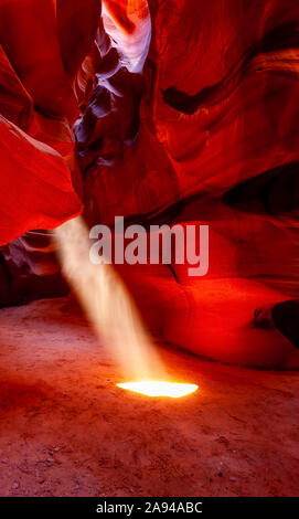 Upper Antelope Canyon avec un faisceau de lumière du soleil qui brille à travers un trou ressemblant à un projecteur au sol; Arizona, États-Unis d'Amérique Banque D'Images