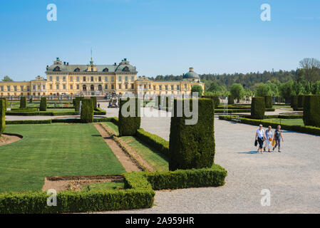 Palais Drottningholm, vue en été des personnes marchant dans le pittoresque jardin baroque formel du palais Drottningholm, île de Lovön, Suède. Banque D'Images