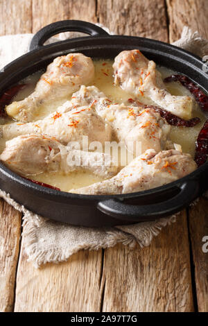 Poulet épicé cuit en fête Rezala sauce yogourt close-up dans une casserole sur la table. vertical Banque D'Images