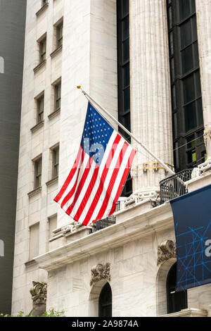 Des drapeaux américains à la Bourse de New York et gratte-ciel en arrière-plan Banque D'Images