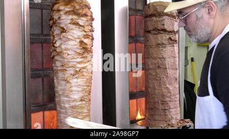 Vienne, Autriche, 9-octobre, 2017 : un cuisinier tranches döner kebab à la célèbre naschtmarkt à vienne, autriche Banque D'Images