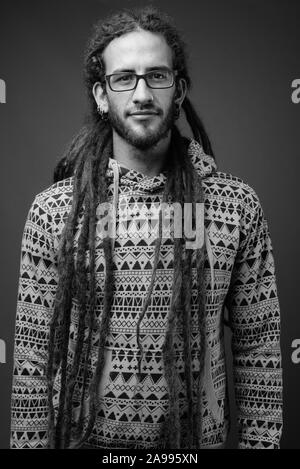 Beau jeune homme hispanique avec des dreadlocks en noir et blanc Banque D'Images