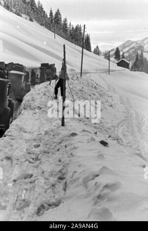 La circulation automobile dans un paysage d'hiver enneigé, Allemagne 1930. Banque D'Images