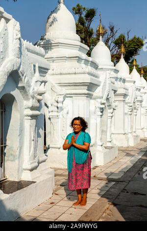 Une femme birmane en priant à la Pagode Kuthodaw, Mandalay, Myanmar. Banque D'Images