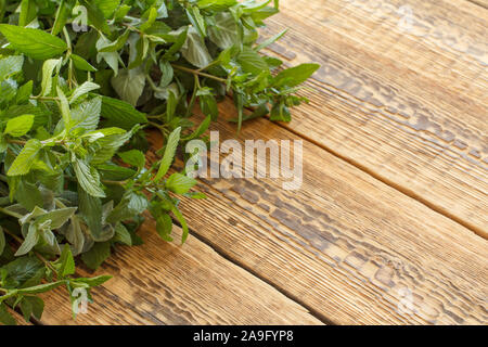 Rouleau de feuilles de menthe verte fraîche sur les planches de bois. Vue d'en haut. Banque D'Images