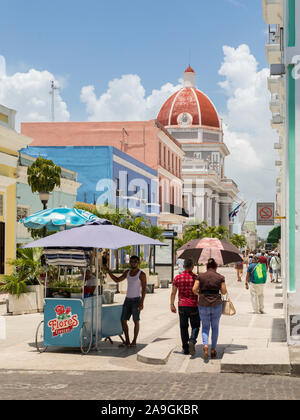 Cienfuegos, Cuba - Juillet 28, 2018 ; les ventes de glace avec streetview et homme shopping avec les gens des provinces du musée en arrière-plan pendant la journée en été Banque D'Images