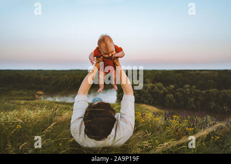 Père et fille de bébé portant sur l'herbe à l'extérieur vie de la famille papa et bébé à marcher ensemble les vacances d'enfance parentalité concep
