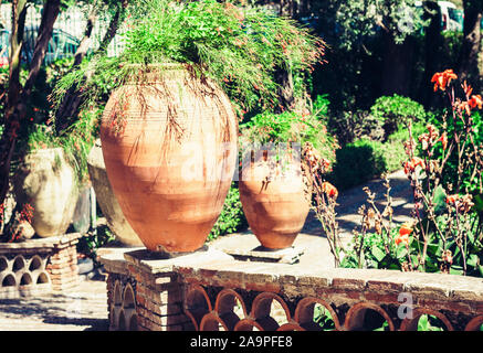 Des pots en argile de décoration avec des plantes et des fleurs près de gazebo dans le Parco Colonna, célèbre parc public à Taormina, Sicile, Italie Banque D'Images