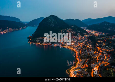 Drone aérien angle haut photo de nuit de la ville des lumières de rue par le lac monte salvatore à Lugano, Suisse Banque D'Images