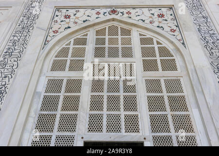 Magnifique fenêtre en marbre avec ornements de détails et pierres précieuses colorées du Taj Mahal. Banque D'Images