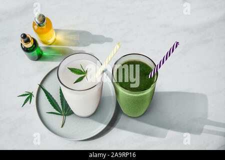 Smoothie concept avec le cannabis et CBD. Lunettes avec des boissons fraîches, du lait et des smoothies, avec le chanvre. Mise à plat. Banque D'Images