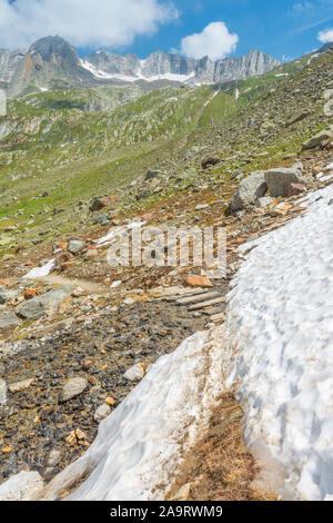 Mur de montagne, mur de pierre debout au-dessus de la vallée environnante. La neige a couvert sentier de randonnée. Champ de blocs tombant du montagnes. Banque D'Images