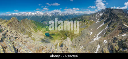 Vue panoramique depuis le sommet, vue sur la Valle Aurina - Ahrntal. Blue lac alpin entouré de montagnes escarpées. Sommets enneigés des Alpes. Banque D'Images