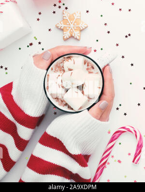 Close up of female hands holding cozy mug de chocolat chaud Banque D'Images
