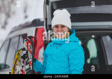 KAZKOVA POLIANA, UKRAINE - le 26 janvier 2019 : Rencontre femme à ski. voiture avec coffre ouvert Banque D'Images