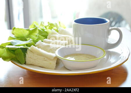 Pain rouleau rempli bologne et chêne vert avec du café sur la plaque Banque D'Images