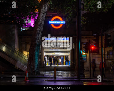 Londres, Angleterre, Royaume-Uni - Octobre 14, 2019 Les navetteurs : promenade à travers la station de Londres remblai éclairés la nuit. Banque D'Images