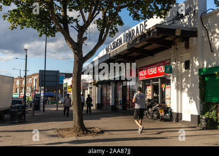 Londres, ANGLETERRE - 1 septembre 2019 : Shoppers à pied passé Neasden Parade, un bâtiment moderniste du début du xxe siècle dans la banlieue de Londres "etroland'. Banque D'Images