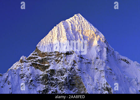 Aube lumière sur le sommet du pic de coin de Pang Pema dans la région du Kangchenjunga est du Népal. Banque D'Images