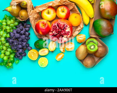 Les fruits et légumes riches en antioxydants, en vitamines et en fibres sur fond bleu. Zéro déchets food shopping, sacs en papier naturel eco style mise à plat Banque D'Images