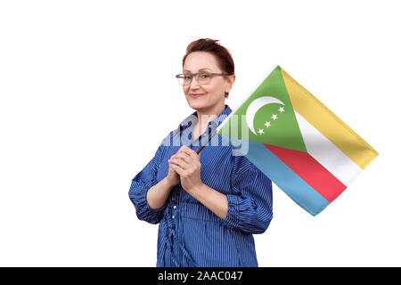 Drapeau des îles Comores. Femme tenant un drapeau. Beau portrait de femme d'âge moyen 40 50 ans la tenue d'un grand drapeau isolé sur fond blanc. Banque D'Images