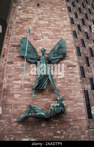 Sculptures en bronze de Saint Michel et le diable par Jacob Epstein sur le mur près de l'entrée de la cathédrale de Coventry Banque D'Images