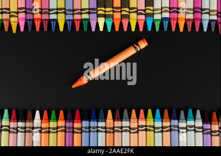Un crayon de couleur orange autour de la ligne colorée des crayons Banque D'Images
