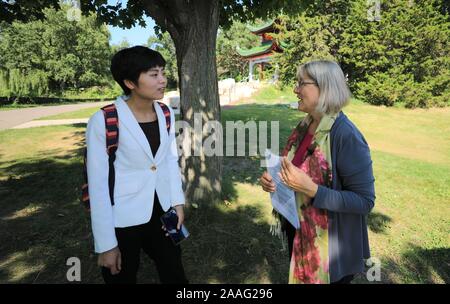 Saint Paul, États-Unis. 21 Nov, 2019. Linda Mealey-Lohmann (R), président de la Société du jardin de l'Amitié Chine du Minnesota, est interviewé dans la Chine Xinhua avec jardin à Saint Paul, aux États-Unis, le 6 août 2019. Situé à Phalen Park à Saint Paul, la capitale de l'État américain du Minnesota, le 1,2-acre China garden, ou Liu Yuan Ming, est devenu un symbole du Minnesota's longue amitié avec la Chine et une reconnaissance de la relation ville-soeur a débuté en 1988 entre saint Paul et Changsha, un centre ville chinoise. Credit : Zhang Mocheng/Xinhua/Alamy Live News Banque D'Images