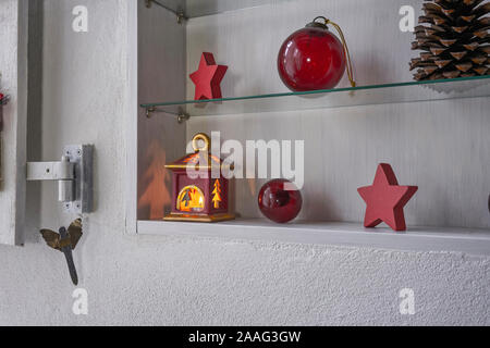 Décoration de Noël rouge et or dans un plateau blanc, étoile, la lampe avec la lumière des bougies, des boules de noël et fir cone Banque D'Images