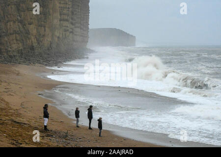 West Bay, Dorset, UK. 22 novembre 2019. Météo britannique. Les enfants regardant la mer difficile crash à terre sur la plage de West Bay, dans le Dorset après une matinée de pluie. Crédit photo : Graham Hunt/Alamy Live News Banque D'Images