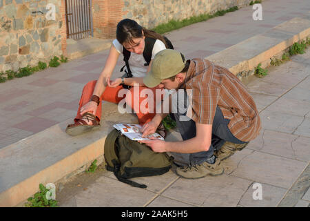 Un jeune couple à la recherche d'information dans un guide touristique. Marrakech, Maroc Banque D'Images