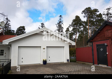 Blanc nouveau garage pour deux voitures et grange en bois sur une maison privée de triage. Banque D'Images