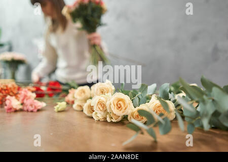 European shop concept. Femme fleuriste crée belle rouge bouquet de fleurs. Beau bouquet frais. L'éducation, master class et Banque D'Images