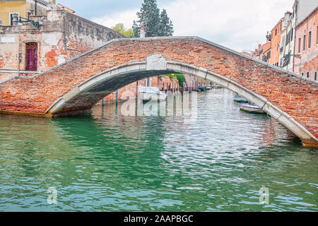 Vieux pont de briques rouges et de l'eau canal in Venice Banque D'Images