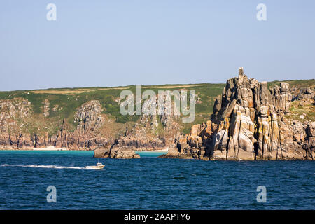 Teryn Dinas et plage de Porthcurno, West Penwith, Cornwall, UK à partir de la mer sur une calme journée d'été Banque D'Images