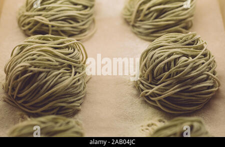 Pâtes fraîches (épinards Spaghetti) dans un style classique sur fond blanc. La cuisine du terroir. Banque D'Images