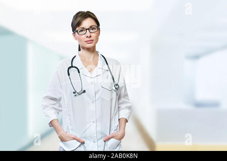 Portrait of serious doctor with stethoscope looking at camera.médecin médecin femme bleu sur fond de la clinique Banque D'Images