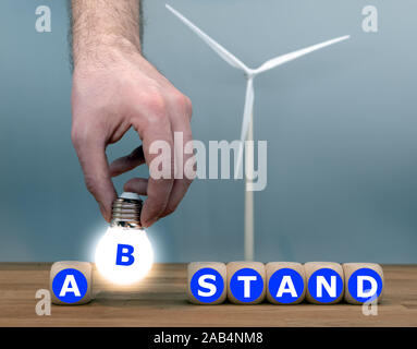 Le symbole d'une distance minimale entre une éolienne et les zones résidentielles. Formulaire dés le mot allemand 'Abstand' ('Distance' en anglais). Banque D'Images